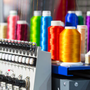 Spools of color threads closeup, spinning machine